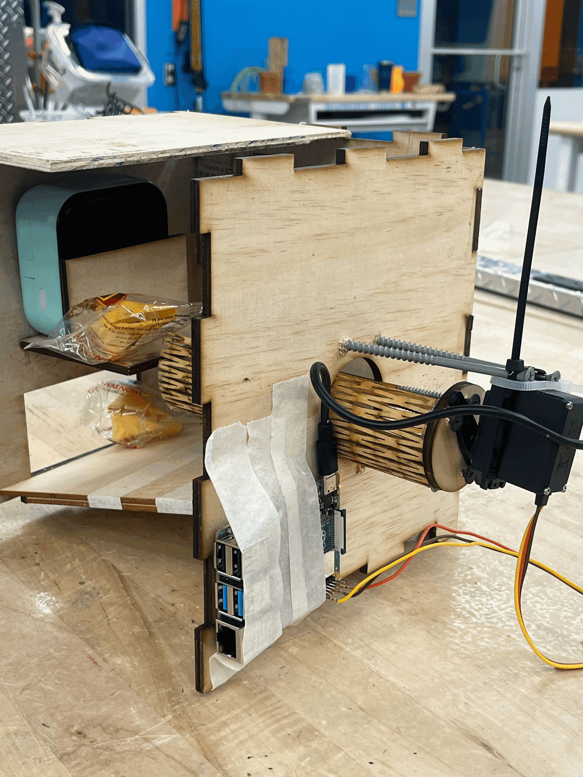 Kiosk internals with Raspberry Pi, servo motor, and laser-cut cookie drum
